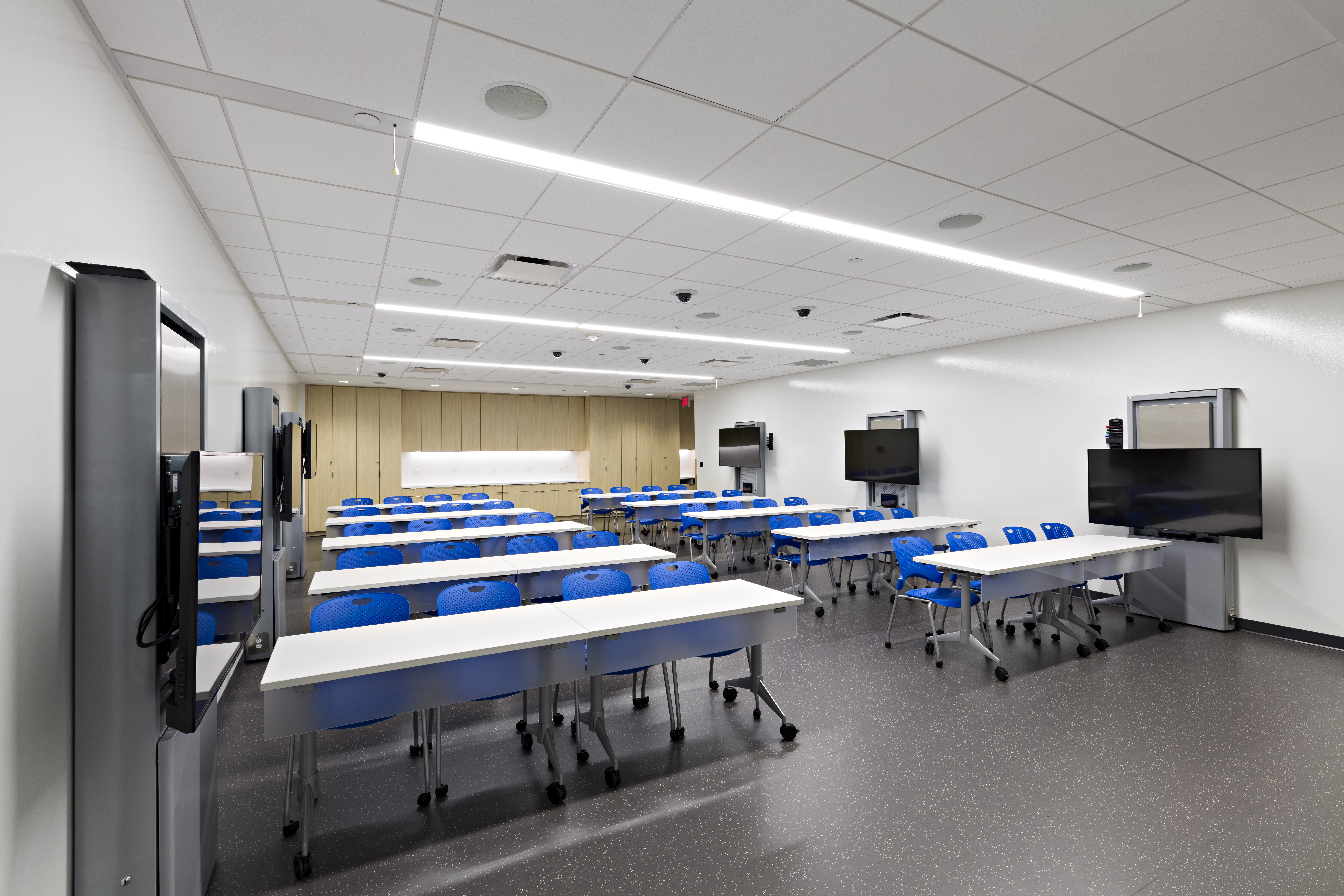The classroom at the Center for Procedural Innovation on the Mayo Clinic Scottsdale campus, with seating for up to 48 people and 7 wall-mounted monitors.